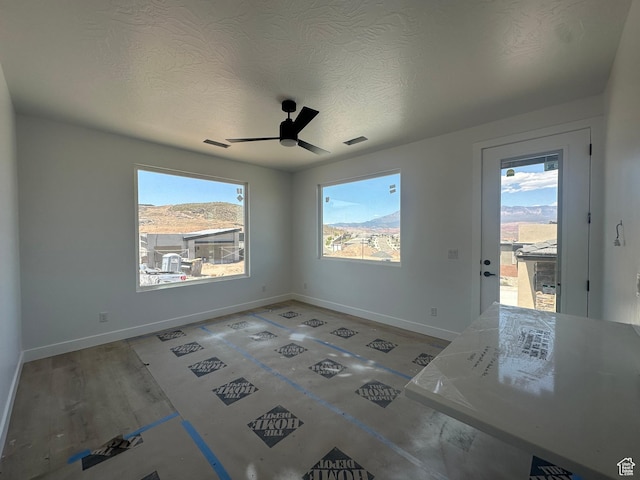 591 S 1800 W, Hurricane, UT 84737 - empty room featuring ceiling fan, baseboards, a textured ceiling, and plenty of natural light