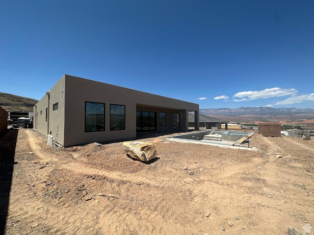 591 S 1800 W, Hurricane, UT 84737 - back of property featuring a swimming pool, stucco siding, and a mountain view