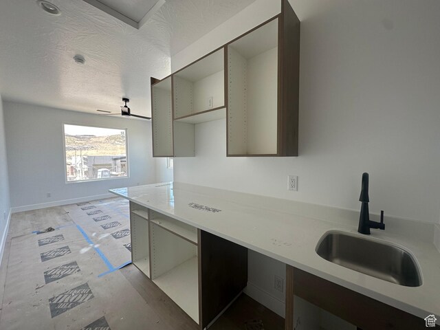 591 S 1800 W, Hurricane, UT 84737 - kitchen with baseboards, a sink, a textured ceiling, and light countertops