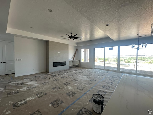591 S 1800 W, Hurricane, UT 84737 - unfurnished living room with ceiling fan with notable chandelier, a tiled fireplace, baseboards, and a textured ceiling