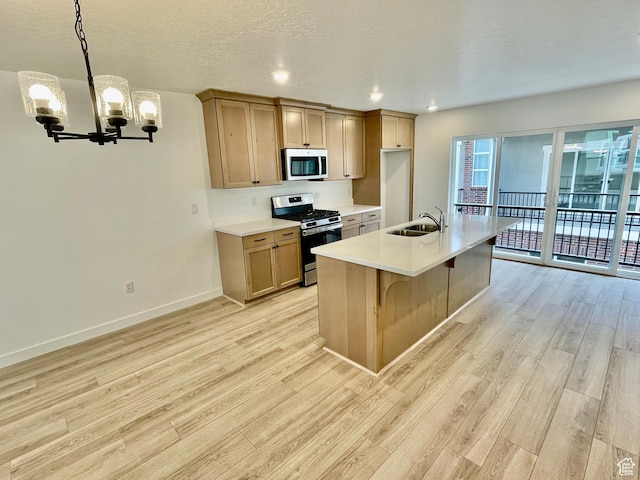 12941 S Corona Arch Ct Unit 571, Riverton, UT 84096 - kitchen with a chandelier, light wood-type flooring, a sink, and appliances with stainless steel finishes
