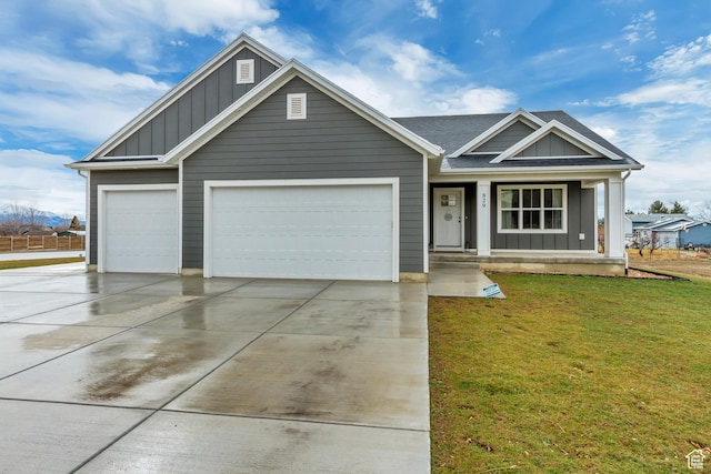 view of front of house with a garage, concrete driveway, a front lawn, a porch, and board and batten siding