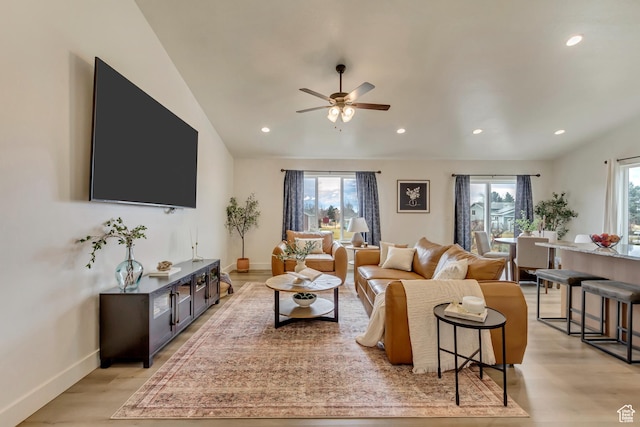 living area with plenty of natural light, recessed lighting, light wood-type flooring, and baseboards