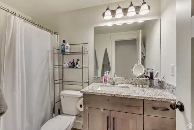 full bathroom featuring vanity and toilet