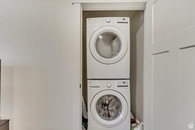 laundry room featuring laundry area and stacked washer and clothes dryer