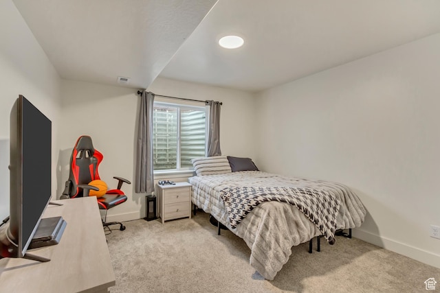 bedroom with visible vents, baseboards, and light colored carpet