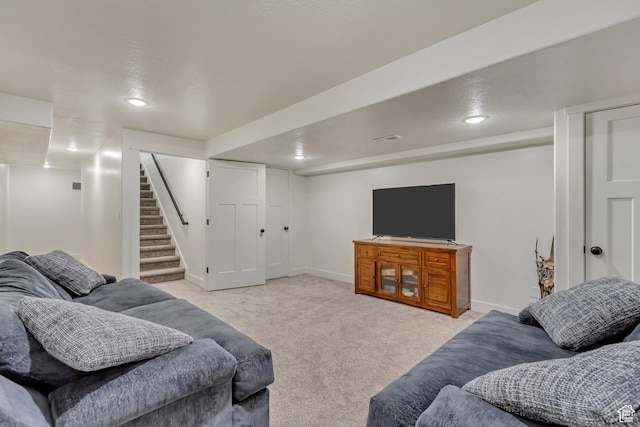 living room featuring recessed lighting, light carpet, stairway, and baseboards