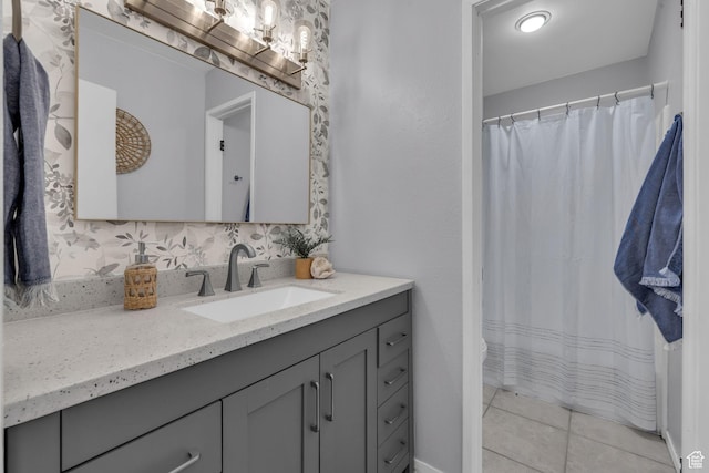 full bath with curtained shower, vanity, and tile patterned floors