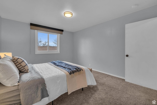bedroom featuring carpet and baseboards