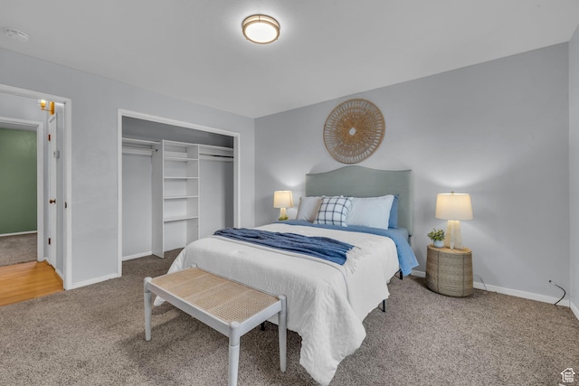 carpeted bedroom with baseboards and a closet