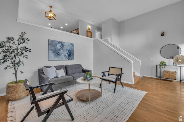 living room featuring recessed lighting, stairway, baseboards, and wood finished floors