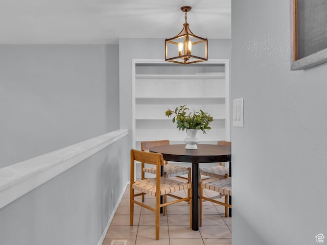 dining area featuring a chandelier and light tile patterned floors