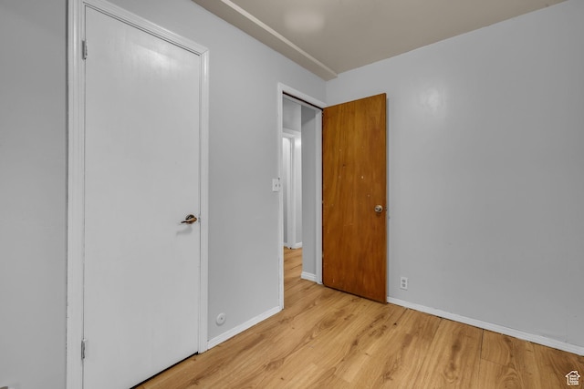 unfurnished bedroom with light wood finished floors and baseboards