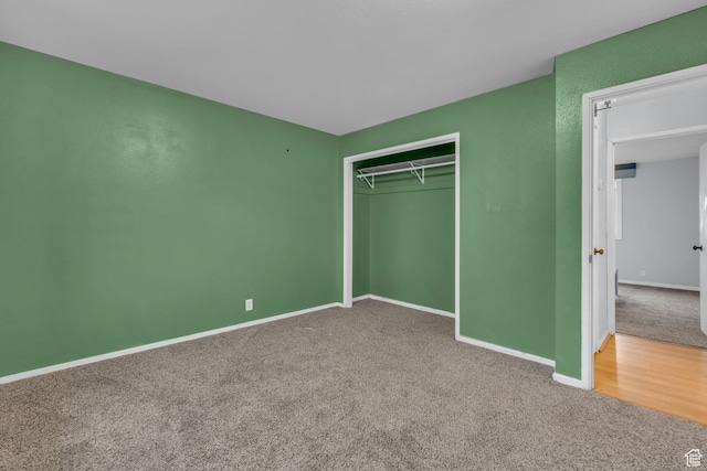 unfurnished bedroom featuring a closet, carpet flooring, and baseboards
