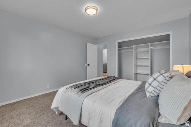carpeted bedroom with a closet and baseboards