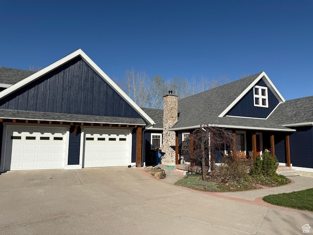 550 N 200 E, Wellsville, UT 84339 - view of front of home featuring a porch, a shingled roof, a chimney, concrete driveway, and an attached garage
