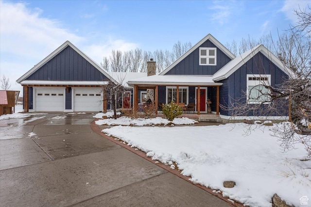 view of front of property with driveway, a chimney, an attached garage, a porch, and board and batten siding