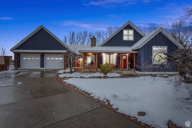 550 N 200 E, Wellsville, UT 84339 - view of front of property featuring a chimney, board and batten siding, covered porch, driveway, and an attached garage