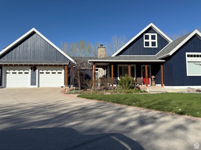 550 N 200 E, Wellsville, UT 84339 - craftsman-style house featuring covered porch, a garage, a chimney, and a front yard