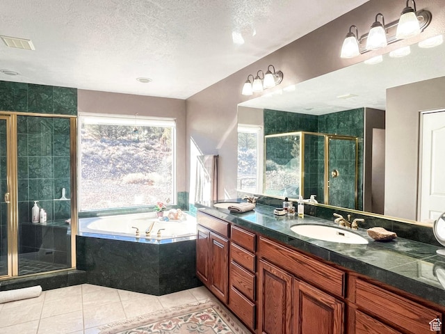 full bathroom featuring visible vents, a stall shower, a sink, tile patterned flooring, and a bath