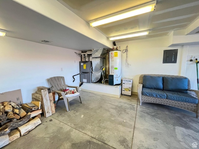 garage with water heater, visible vents, electric panel, and heating unit
