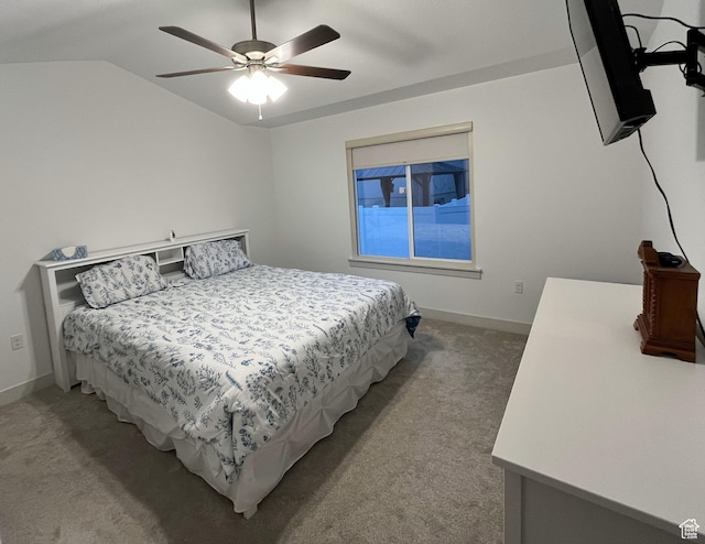 bedroom featuring light colored carpet, baseboards, lofted ceiling, and ceiling fan