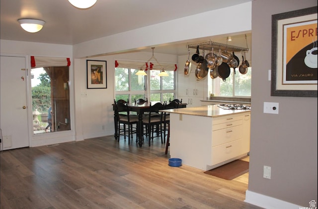 134 E 175 S, North Salt Lake, UT 84054 - kitchen featuring baseboards, white cabinets, wood finished floors, light countertops, and stainless steel gas stovetop