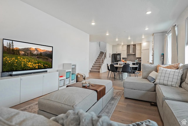 living room with stairway, wood finished floors, and recessed lighting