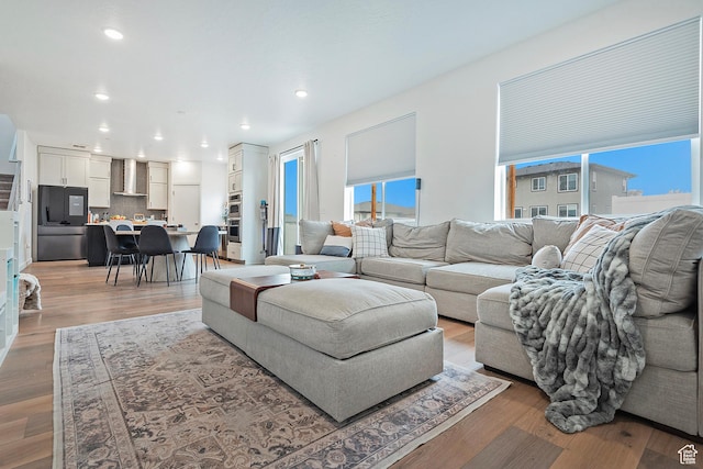 living room with light wood finished floors and recessed lighting