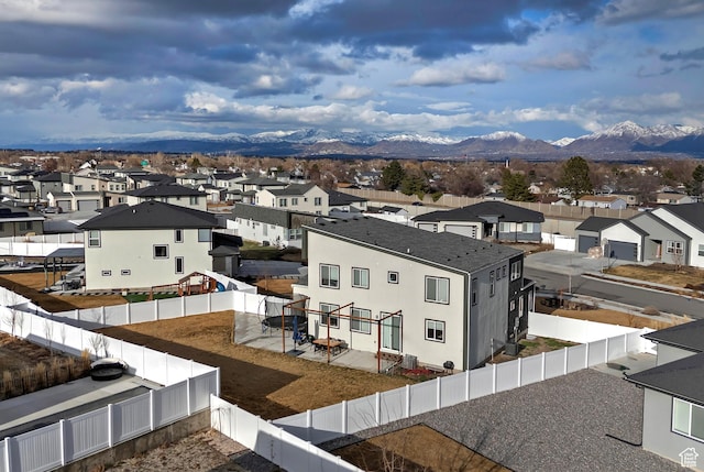 drone / aerial view featuring a residential view and a mountain view