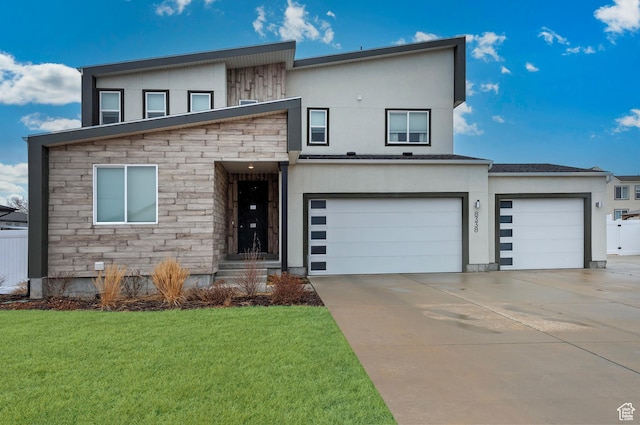 contemporary house with a front yard, stone siding, driveway, and stucco siding
