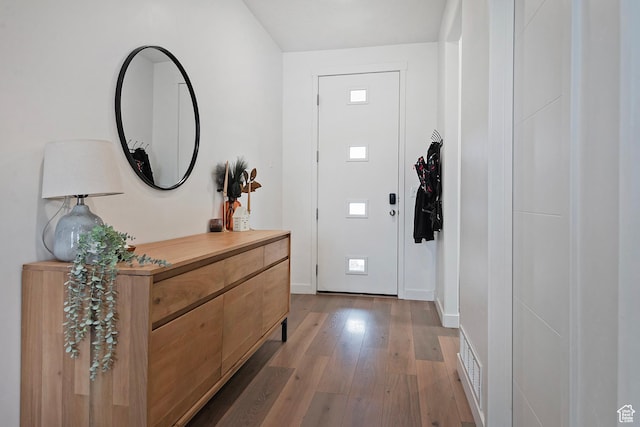 entrance foyer featuring light wood-type flooring and baseboards