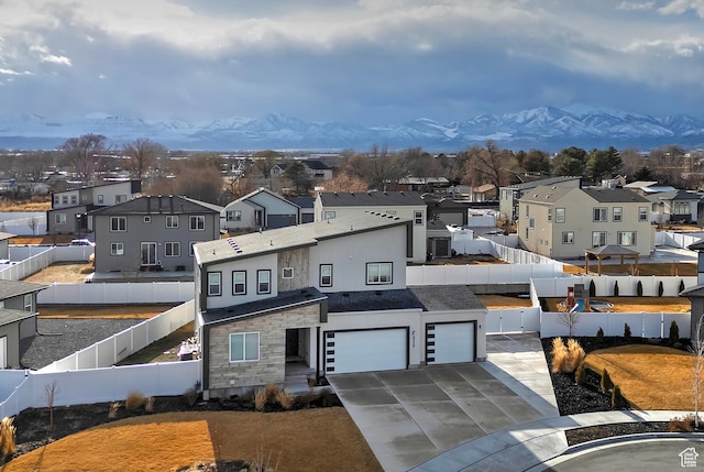 view of front of property featuring a mountain view, fence private yard, and a residential view