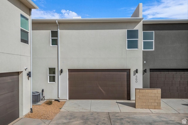 560 W Aqua Cv Unit 506, St George, UT 84790 - view of front facade with an attached garage, concrete driveway, central AC, and stucco siding