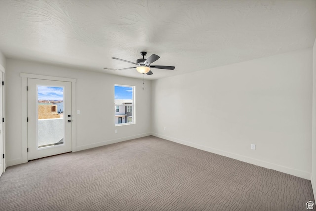 560 W Aqua Cv Unit 506, St George, UT 84790 - spare room featuring light carpet, a ceiling fan, and baseboards