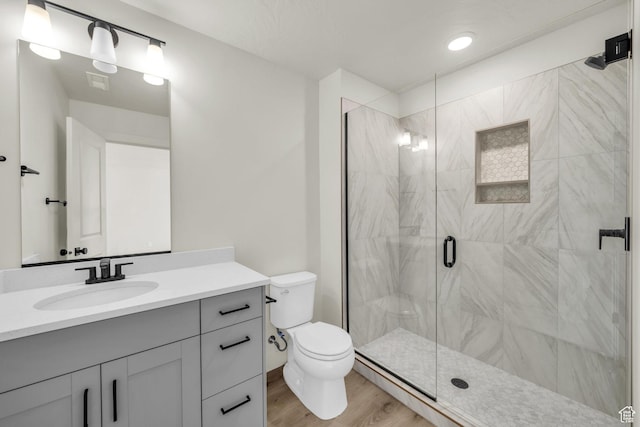 560 W Aqua Cv Unit 506, St George, UT 84790 - bathroom featuring visible vents, toilet, a shower stall, vanity, and wood finished floors