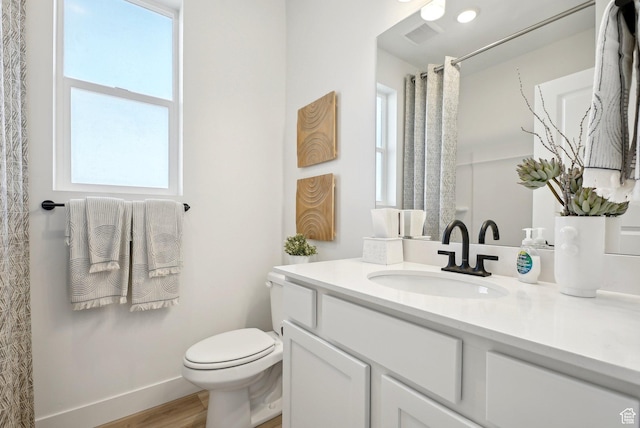 bathroom featuring vanity, toilet, baseboards, wood finished floors, and a shower with curtain