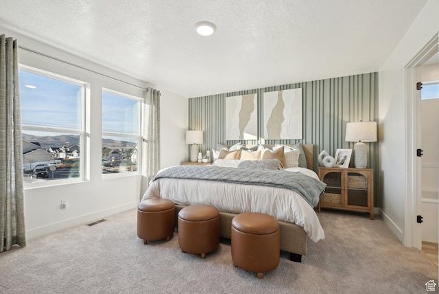 carpeted bedroom with visible vents and baseboards