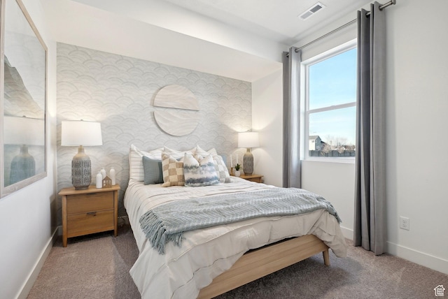 carpeted bedroom featuring baseboards, visible vents, and wallpapered walls