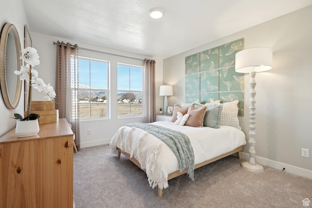 bedroom with baseboards and light carpet