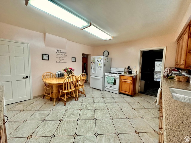 516 S Freedom Blvd, Provo, UT 84601 - kitchen with white appliances, a sink, light countertops, brown cabinets, and light floors