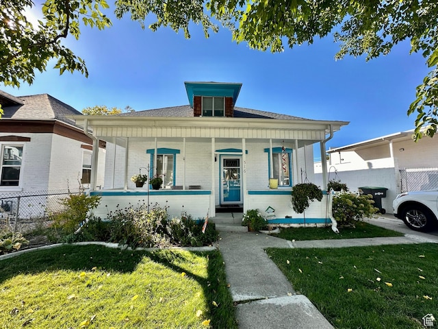 516 S Freedom Blvd, Provo, UT 84601 - bungalow-style home featuring a front lawn, fence, a porch, and brick siding