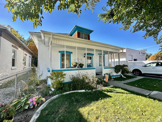 516 S Freedom Blvd, Provo, UT 84601 - bungalow-style home featuring a porch, brick siding, fence, and a front lawn