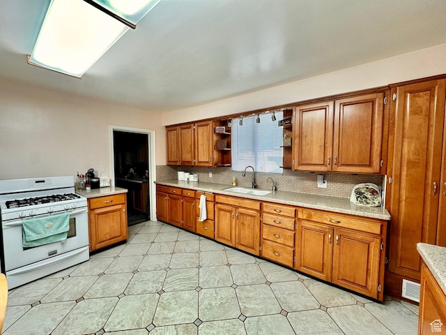 516 S Freedom Blvd, Provo, UT 84601 - kitchen with white range with gas stovetop, a sink, light countertops, open shelves, and brown cabinetry