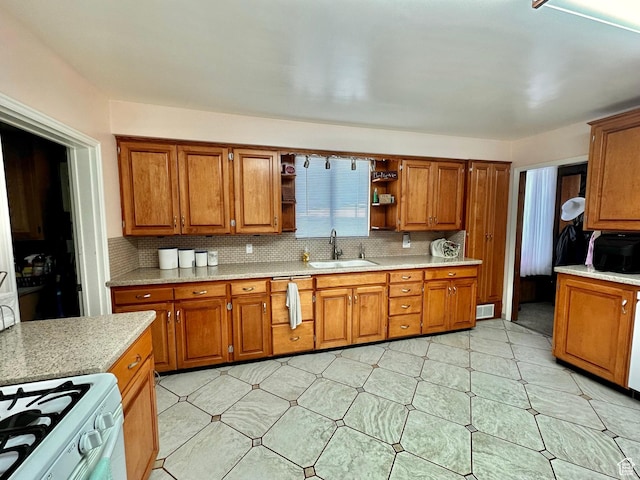 516 S Freedom Blvd, Provo, UT 84601 - kitchen with open shelves, tasteful backsplash, brown cabinetry, and a sink