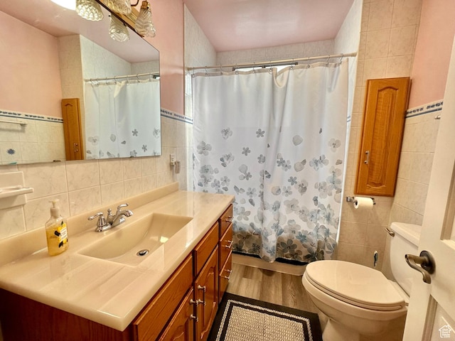 516 S Freedom Blvd, Provo, UT 84601 - bathroom with toilet, wood finished floors, vanity, and tile walls
