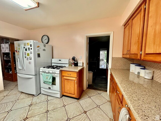 516 S Freedom Blvd, Provo, UT 84601 - kitchen featuring light tile patterned floors, white appliances, brown cabinetry, and backsplash