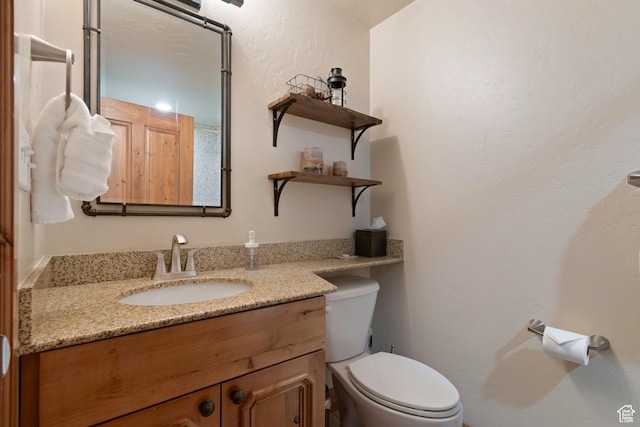 bathroom featuring vanity and toilet