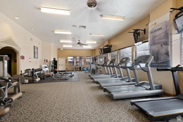 gym featuring visible vents, a wealth of natural light, and a textured ceiling