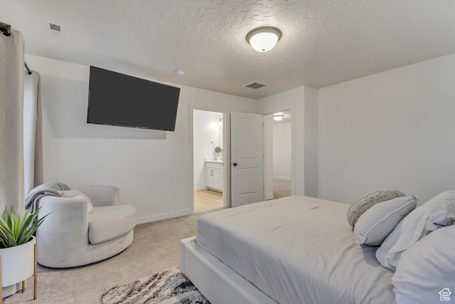 bedroom featuring light colored carpet, visible vents, a textured ceiling, and baseboards